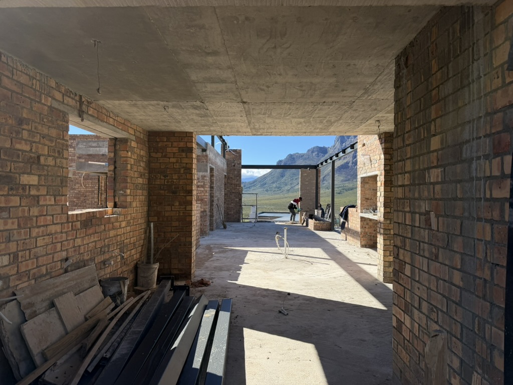 Johannesdal — brick interior under construction framing the mountain view